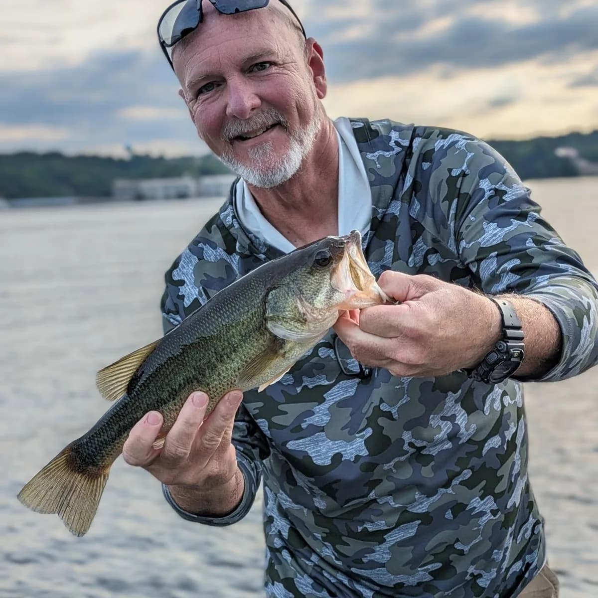 An angler with a largemouth bass caught off a main-lake point