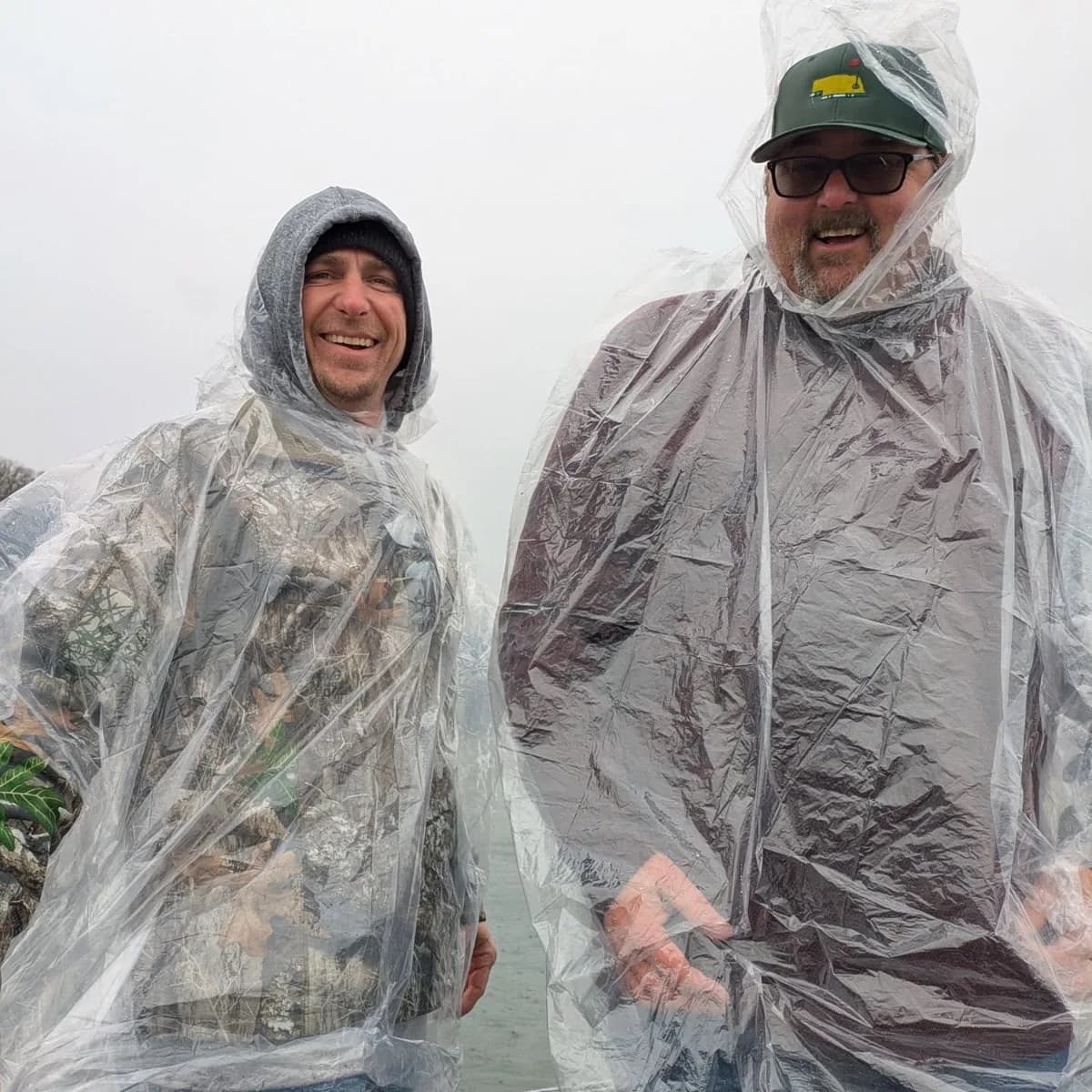 Two anglers in rain ponchos during a March shower