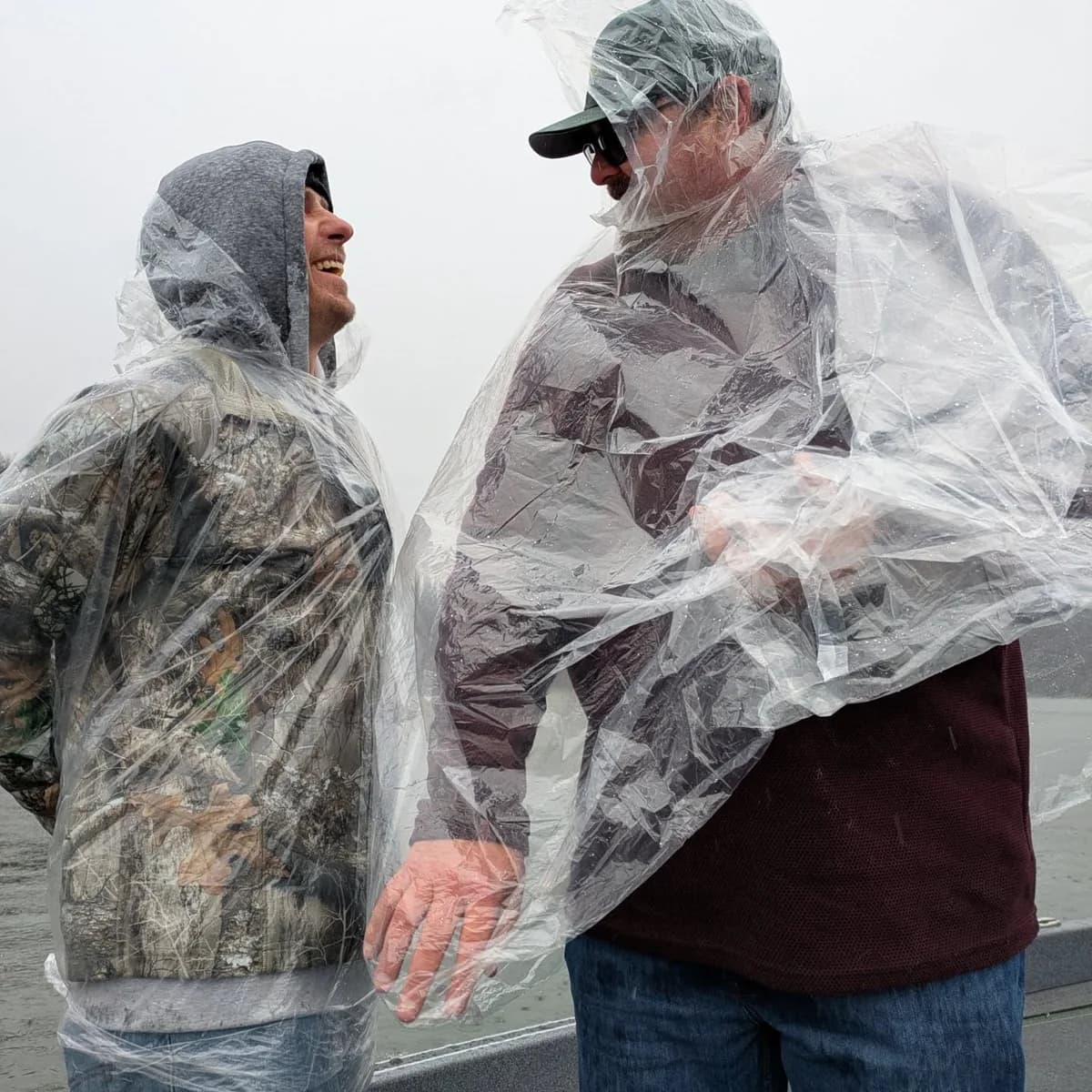 Anglers waiting out the rain in ponchos on the boat