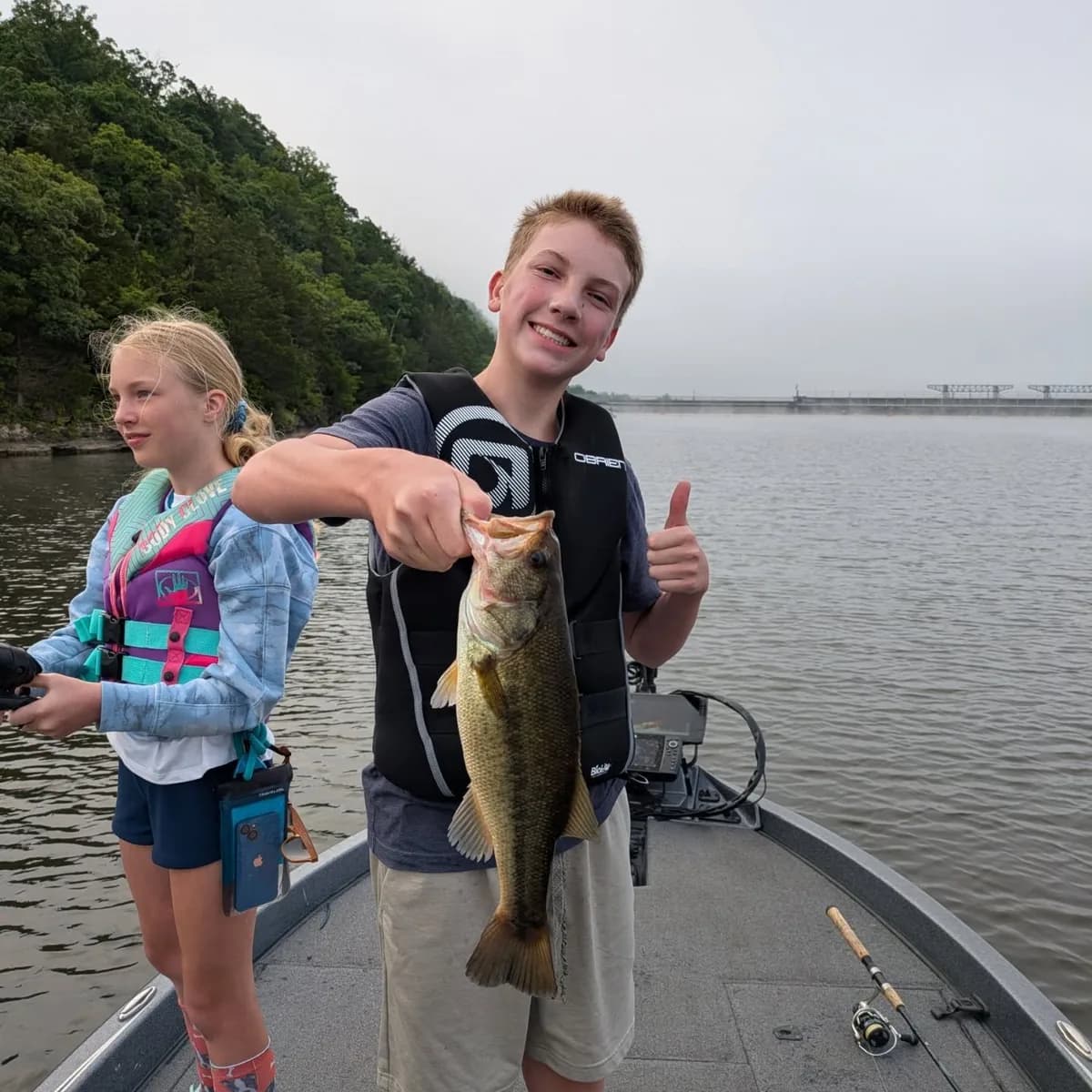 Two young anglers with a largemouth bass on a May trip