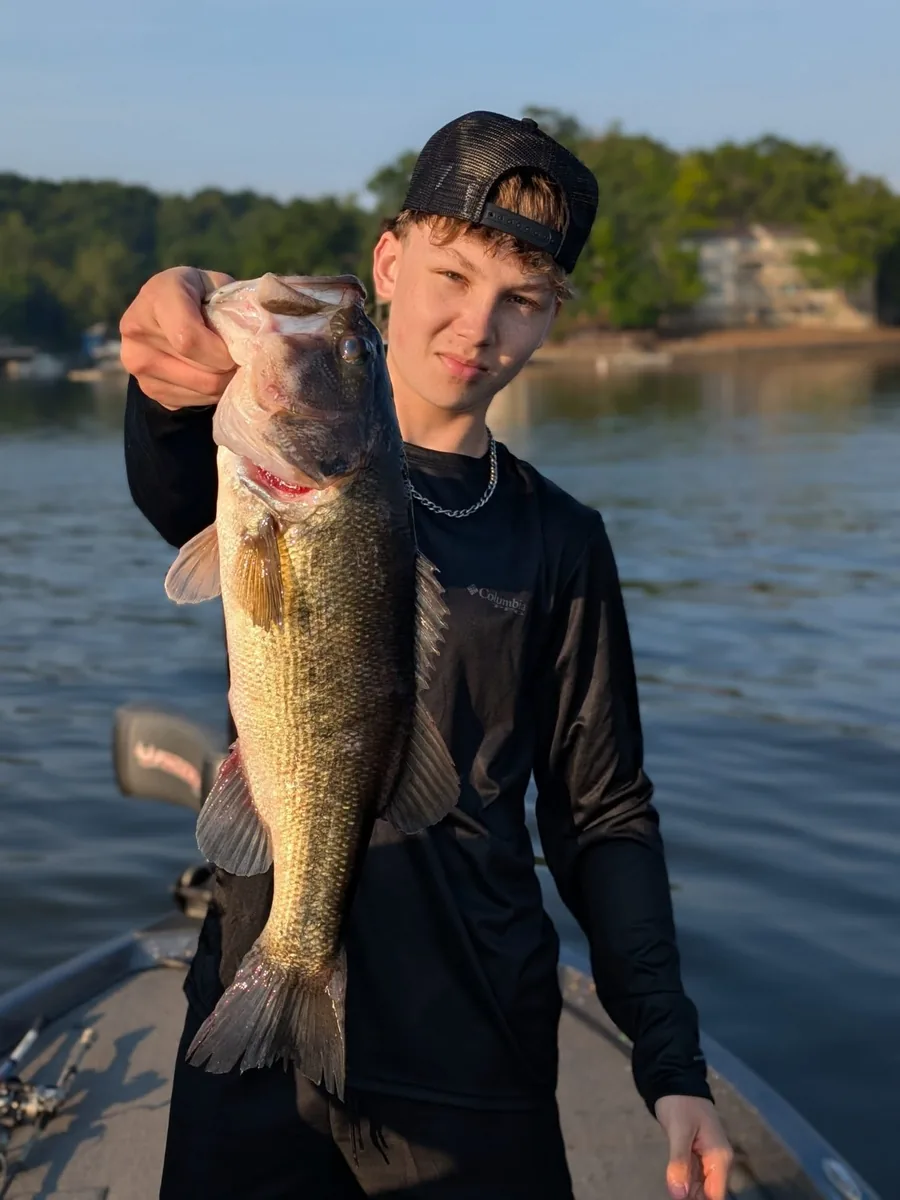 A teenage angler with a good-sized largemouth bass