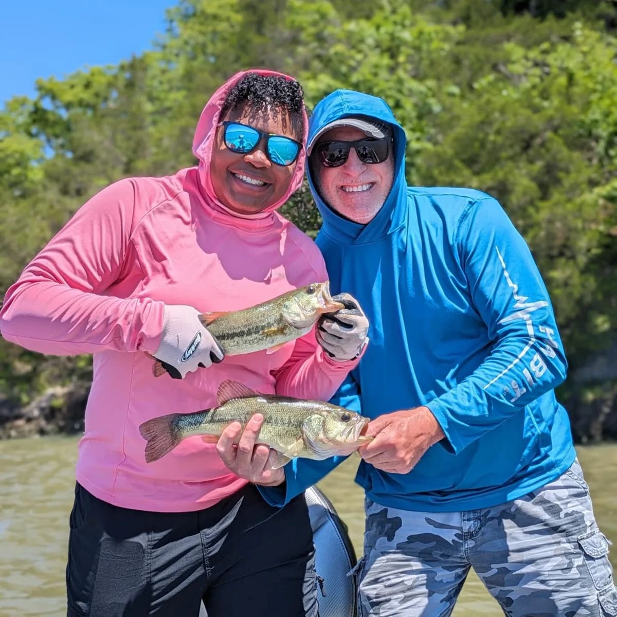 Two anglers with a pair of largemouth bass
